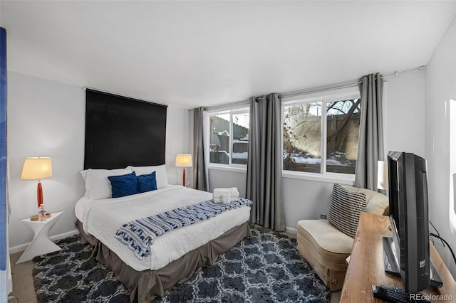 bedroom featuring carpet and baseboards