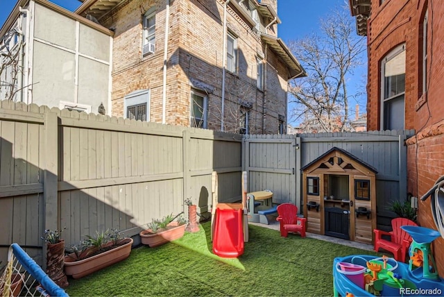 view of playground with a fenced backyard and a yard