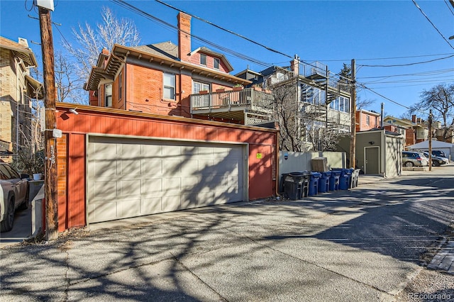 exterior space with a garage and brick siding