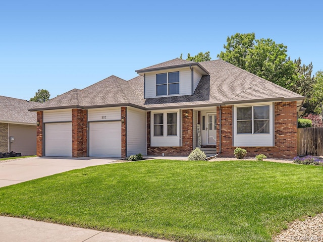 801 51st Ave, Greeley, CO 80634 - view of front facade with a garage, concrete driveway, brick siding, and roof with shingles