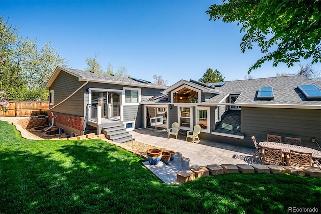 back of house featuring a yard and a patio area