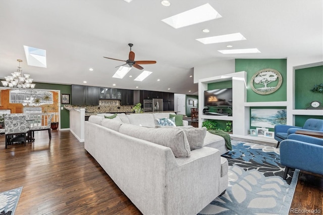 living room featuring ceiling fan with notable chandelier and dark hardwood / wood-style floors