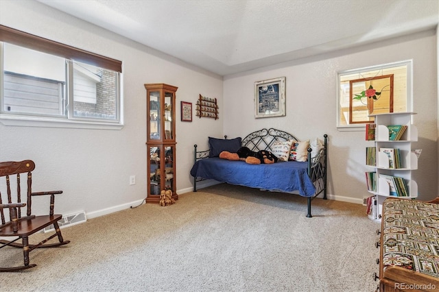 carpeted bedroom featuring a textured ceiling