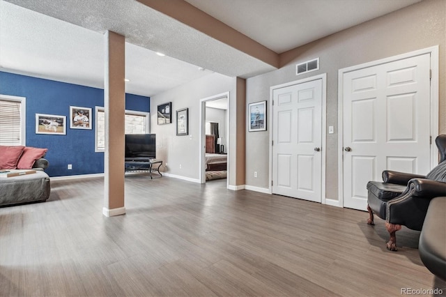 interior space with wood-type flooring and a textured ceiling