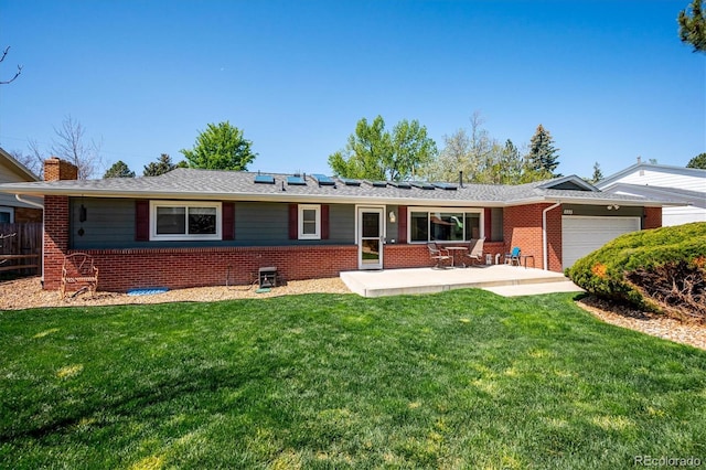 ranch-style home featuring a garage and a front lawn