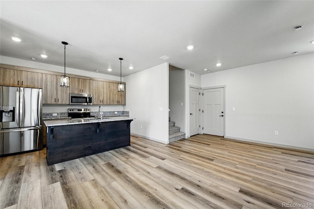 260 E 4th St, Berthoud, CO 80513 - kitchen featuring stainless steel appliances, recessed lighting, light wood finished floors, baseboards, and a sink