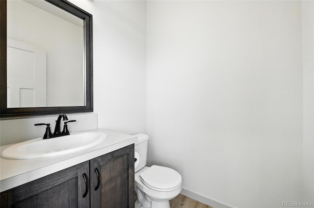 260 E 4th St, Berthoud, CO 80513 - bathroom with toilet, vanity, and baseboards