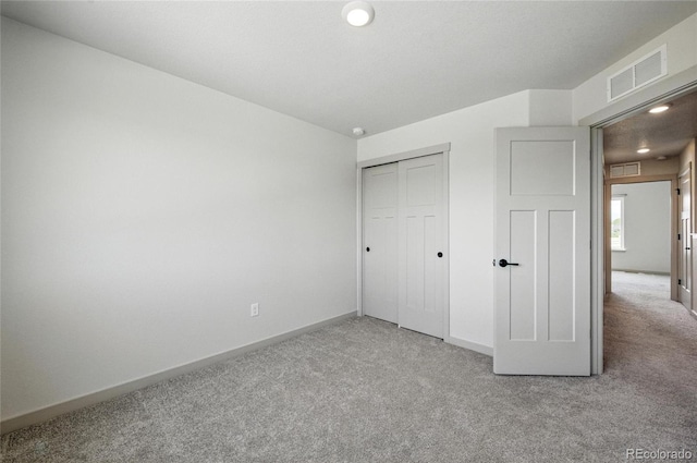 260 E 4th St, Berthoud, CO 80513 - unfurnished bedroom with light carpet, baseboards, and a closet