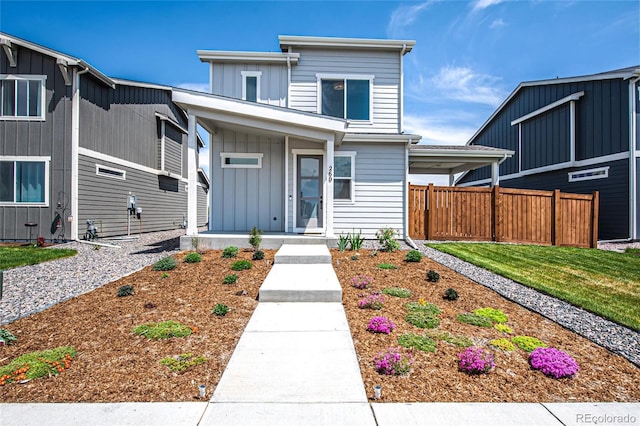 260 E 4th St, Berthoud, CO 80513 - view of front facade featuring board and batten siding, covered porch, and fence