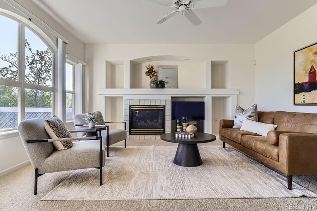 8915 S Field Ct, Littleton, CO 80128 - carpeted living room featuring a ceiling fan and a fireplace