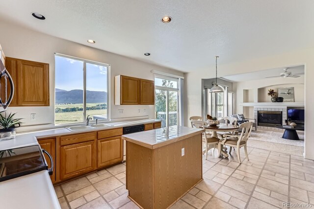 8915 S Field Ct, Littleton, CO 80128 - kitchen with a fireplace, a center island, recessed lighting, a mountain view, and dishwasher
