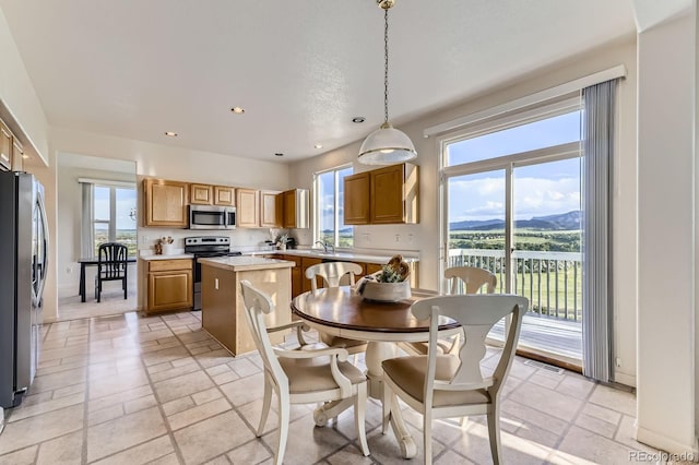 8915 S Field Ct, Littleton, CO 80128 - dining area featuring recessed lighting, plenty of natural light, and stone tile floors