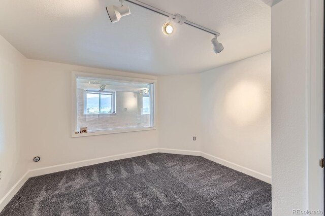 8915 S Field Ct, Littleton, CO 80128 - carpeted empty room featuring rail lighting and baseboards
