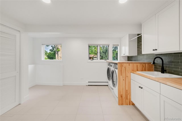 41 Skyline Dr, Wheat Ridge, CO 80215 - laundry area featuring separate washer and dryer, baseboard heating, cabinet space, plenty of natural light, and recessed lighting