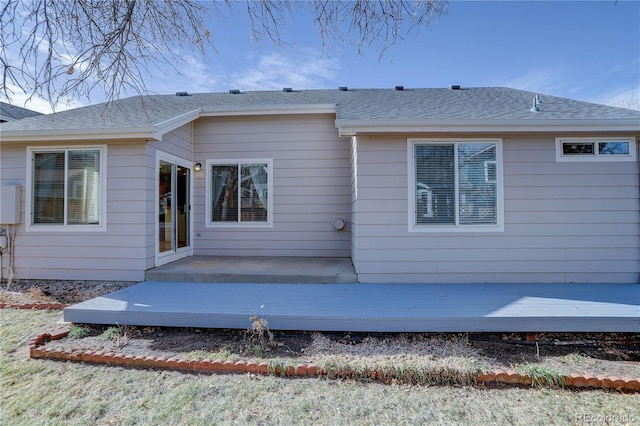 back of property with a wooden deck