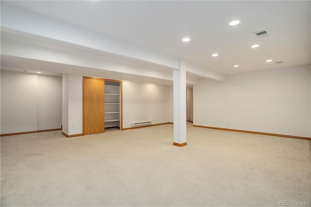 basement featuring a baseboard radiator and light carpet