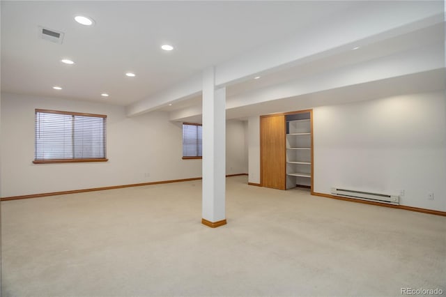 basement with light carpet and a baseboard radiator