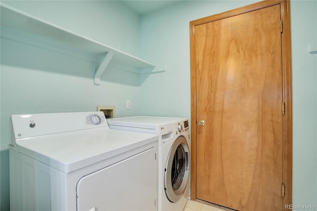 laundry area with separate washer and dryer and light tile patterned flooring