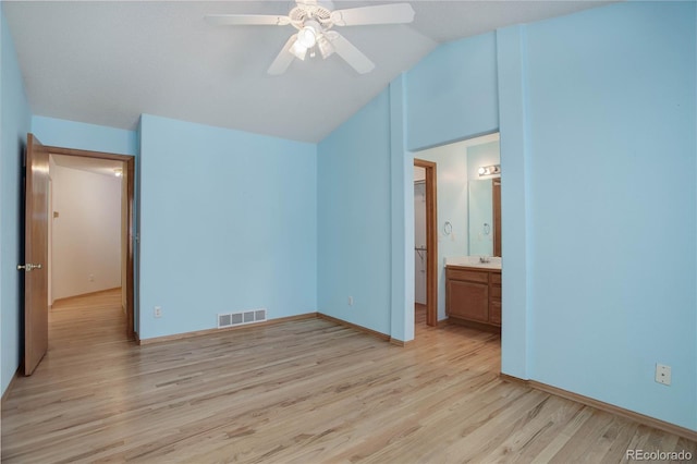 unfurnished bedroom with ensuite bath, sink, light hardwood / wood-style flooring, ceiling fan, and lofted ceiling