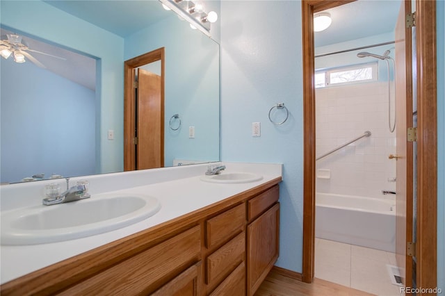 bathroom featuring ceiling fan, tile patterned floors, vanity, and shower / washtub combination