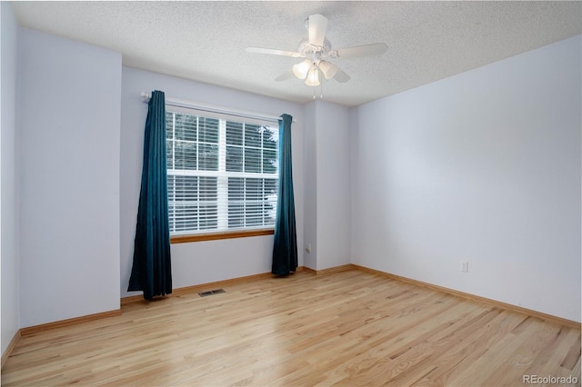 unfurnished room with light wood-type flooring, ceiling fan, and a textured ceiling