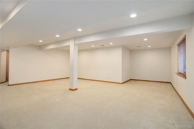 basement featuring light colored carpet