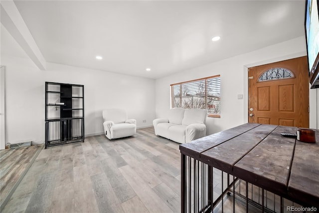 living room with recessed lighting, baseboards, and light wood finished floors