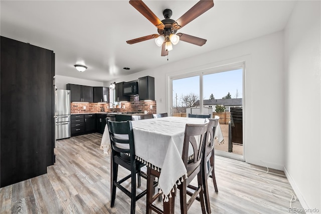 dining area featuring baseboards, a ceiling fan, and light wood-style flooring