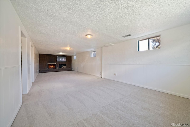 12024 W Maryland Dr, Lakewood, CO 80228 - below grade area with a textured ceiling, a warm lit fireplace, carpet flooring, and wainscoting