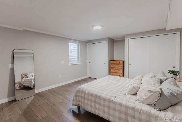 6059 Routt St, Arvada, CO 80004 - bedroom featuring two closets and wood finished floors