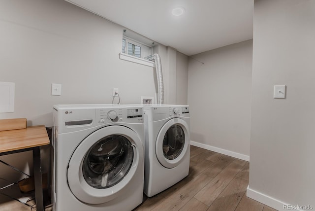 6059 Routt St, Arvada, CO 80004 - laundry room featuring separate washer and dryer and wood finished floors