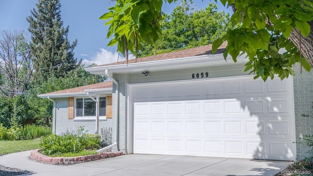 6059 Routt St, Arvada, CO 80004 - garage with concrete driveway