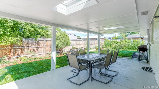 6059 Routt St, Arvada, CO 80004 - sunroom / solarium with a skylight, outdoor dining space, and healthy amount of natural light
