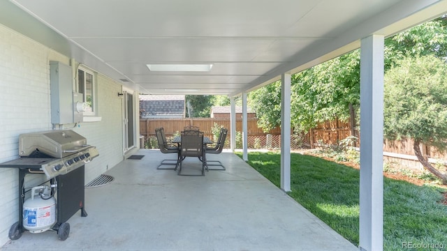 6059 Routt St, Arvada, CO 80004 - fenced backyard with area for grilling, a patio area, and outdoor dining space