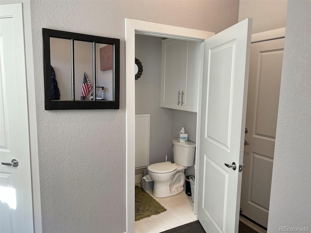 bathroom featuring tile patterned flooring and toilet