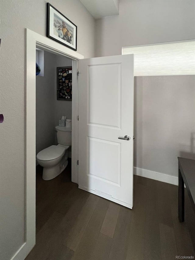 bathroom featuring hardwood / wood-style flooring and toilet