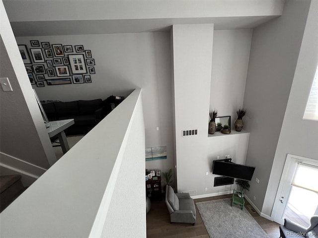 staircase with hardwood / wood-style flooring