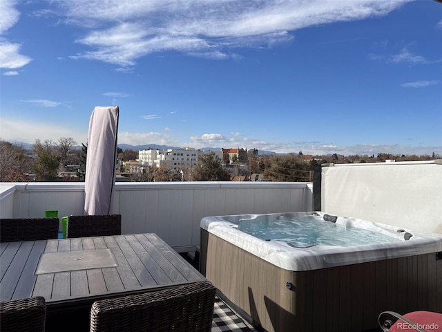 wooden terrace featuring a hot tub