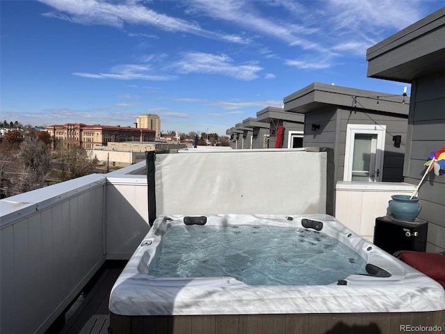 exterior space with a hot tub and a balcony