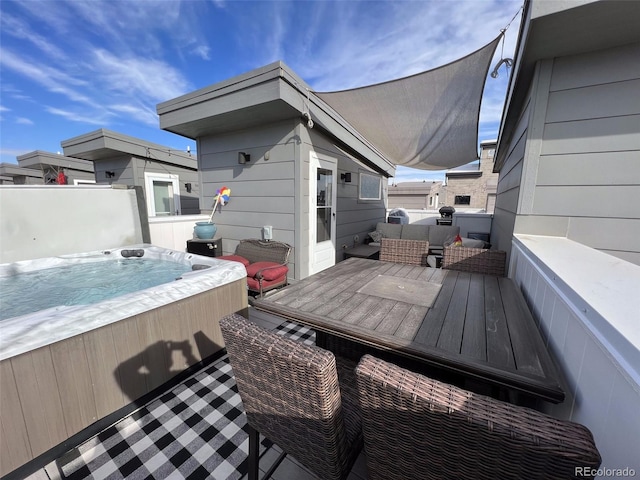 wooden terrace featuring a hot tub