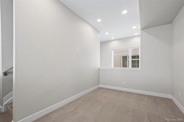 carpeted empty room with stairway, recessed lighting, and baseboards