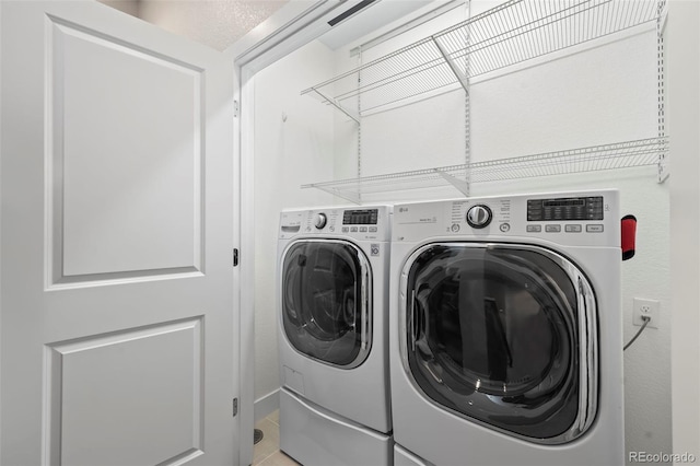 clothes washing area with laundry area and washer and dryer