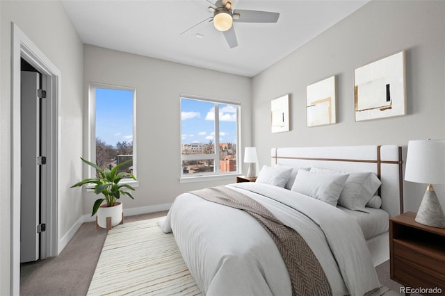 carpeted bedroom featuring a ceiling fan and baseboards