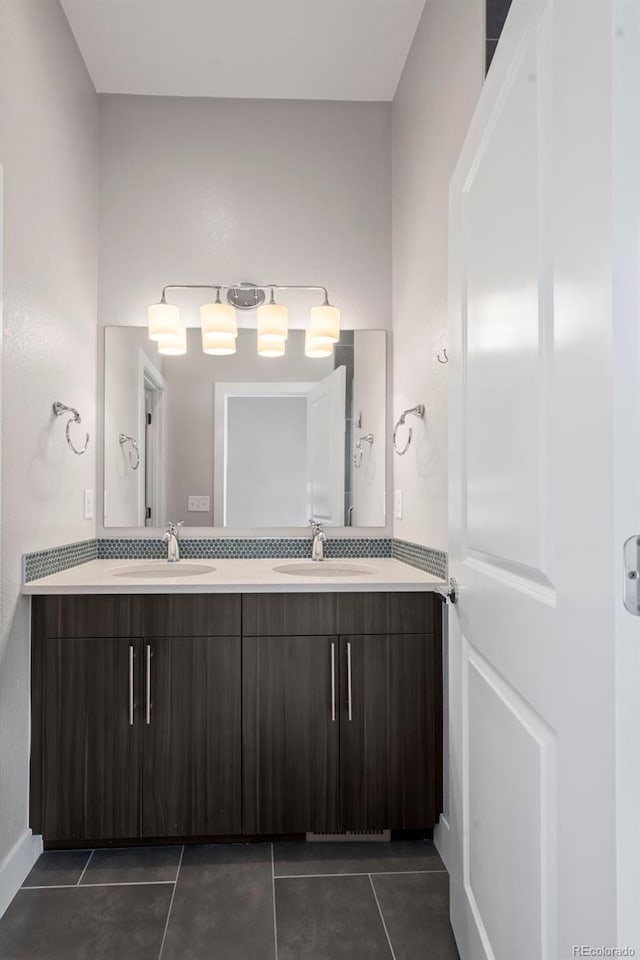 bathroom featuring double vanity, tile patterned flooring, and a sink