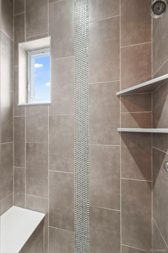 full bath with a tile shower