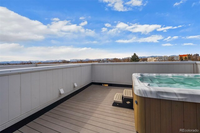 wooden deck with a hot tub