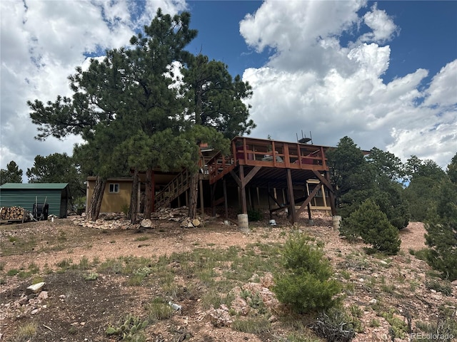 back of house with a deck