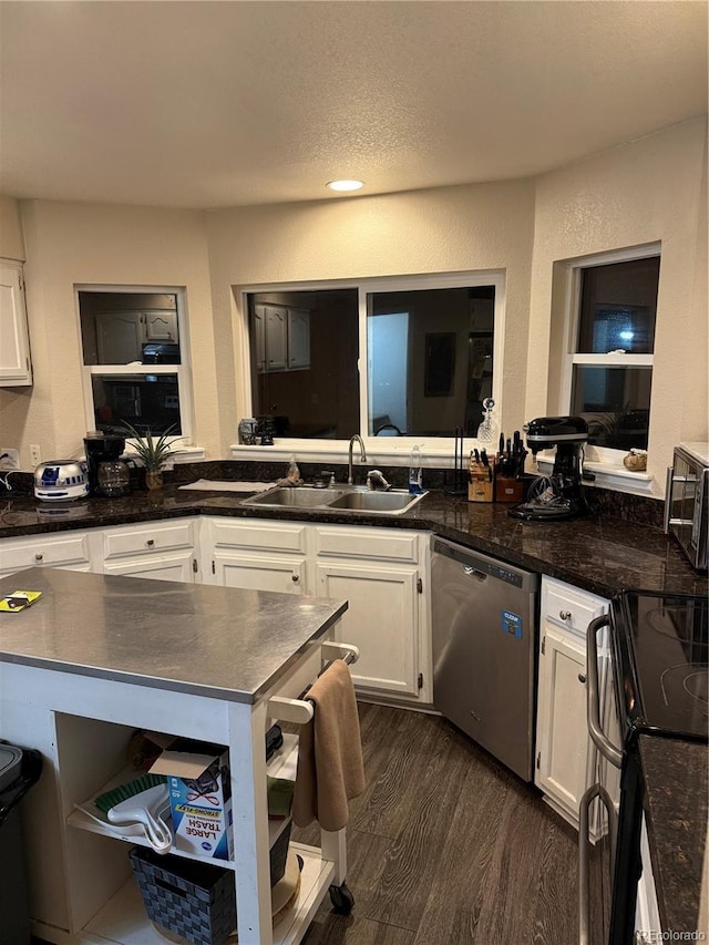 kitchen with a sink, dark wood-style floors, white cabinets, and dishwasher