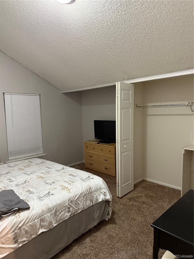 bedroom featuring lofted ceiling, a closet, carpet, and a textured ceiling