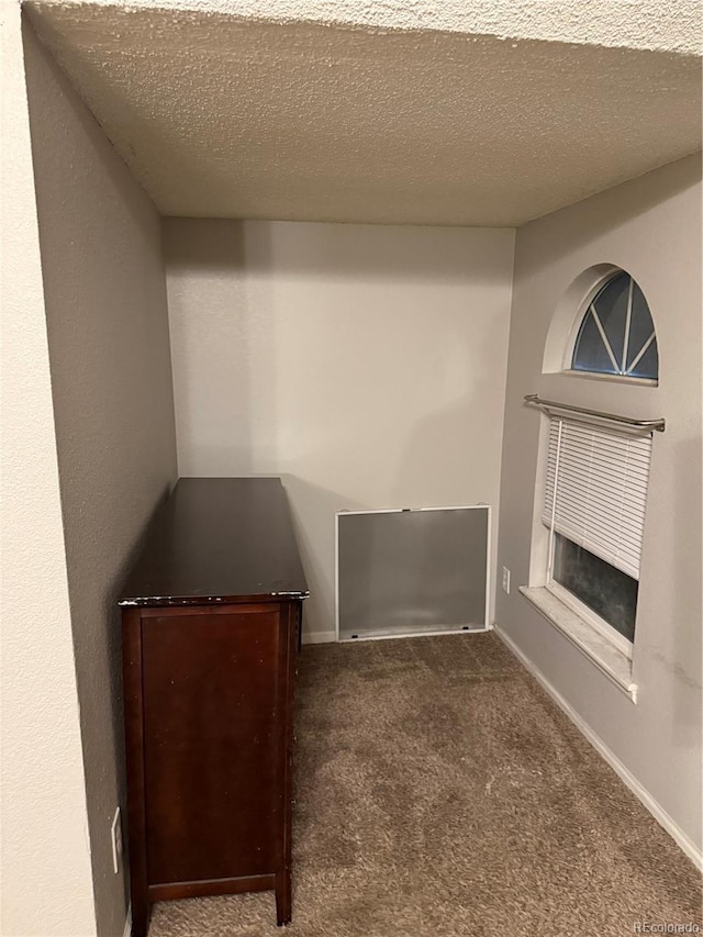 interior space with baseboards and a textured ceiling